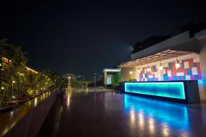 a building with a lit up pool at night at The Alcor Hotel in Jamshedpur
