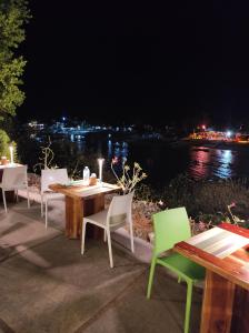 a table and chairs with a view of the water at night at Tepanee Beach Resort in Malapascua Island