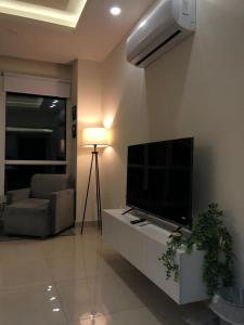 a living room with a flat screen tv and a couch at Elysium Tower Studio Apartments with Centaurus View, Islamabad by LMY in Islamabad