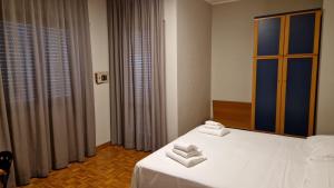 Postel nebo postele na pokoji v ubytování Hotel Dogana