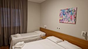 Postel nebo postele na pokoji v ubytování Hotel Dogana