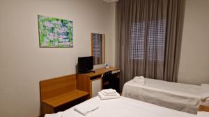 Postel nebo postele na pokoji v ubytování Hotel Dogana
