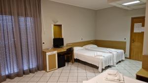 Postel nebo postele na pokoji v ubytování Hotel Dogana