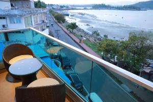 a balcony with a table and a view of the ocean at Sea Deck in Port Blair