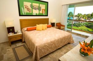 a bedroom with a bed and a large window at Suites at Mayan Palace Vidanta Resort Riviera Maya in Playa del Carmen