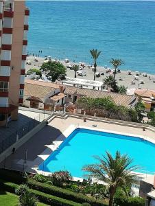 a view of a swimming pool and a beach at Apartamento Peñalver 813 in Torrox Costa