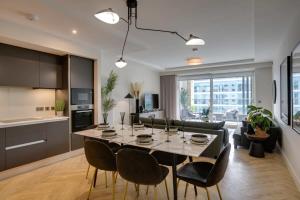 a kitchen and living room with a table and chairs at The Benson One by Dublin At Home in Dublin