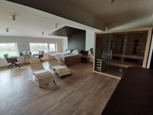 a large living room with a bed and chairs in it at Spa Hera in Šmartno pri Litiji