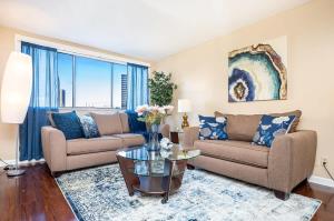 a living room with two couches and a table at ATL Downtown City View Onsite Parking LM802 in Atlanta