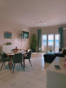 a living room with a table and a couch at By the Sea Luxury Apartment in Nikiti