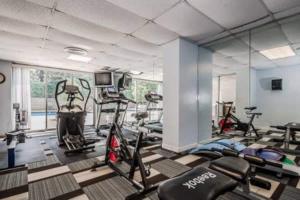 a gym with several treadmills and machines in a room at ATL Downtown City View Onsite Parking LM802 in Atlanta