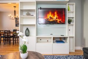 a living room with a fireplace in a white entertainment center at Atlanta Downtown! 1B Paid Onsite Parking! LM301 in Atlanta