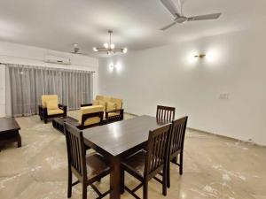 a dining room with a table and chairs at Stelliam's Chic 2 Bhk Sea View Apartment in Goa in Panaji