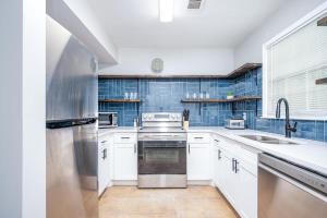 a kitchen with white cabinets and a stainless steel refrigerator at NEW ENTIRE PLACE COZY QUIET 2b2b TOWNHOUSE SP1265 in Norcross