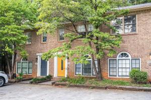 a brick house with a yellow door at NEW ENTIRE PLACE Cozy 2B2B with King Bed SP1263 in Norcross