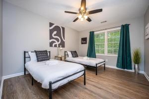 a bedroom with two beds and a ceiling fan at NEW ENTIRE PLACE COZY QUIET 2b2b TOWNHOUSE SP1261 in Norcross