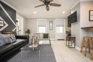 a living room with a couch and a ceiling fan at Downtown! 24h Concierge! Private Balcony! 11K in Atlanta