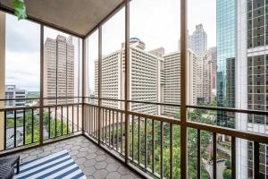 a balcony with a view of the city at Downtown! 24h Concierge! Private Balcony! 11K in Atlanta