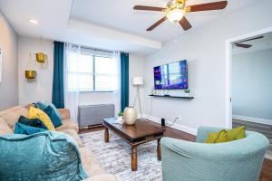 a living room with two couches and a tv at Downtown ! King bed 24 concierge! Onsite Parking LM903 in Atlanta