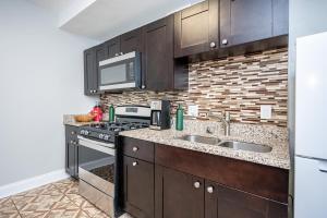 a kitchen with a sink and a stove at Downtown ! King bed 24 concierge! Onsite Parking LM903 in Atlanta