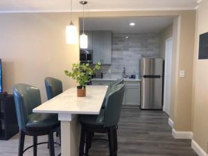 a kitchen with a table with chairs and a refrigerator at Downtown Atlanta! Onsite Parking! 24 CONCIERGE LM908 in Atlanta
