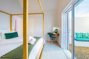 a bedroom with a bed and a desk and a window at Lucky Crane Villas in McGregor +132 photos