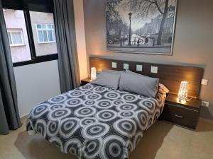 a bedroom with a large bed and a large window at Apartamento Eursu Playa in Málaga