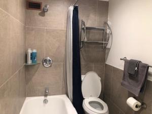 a bathroom with a toilet and a shower and a sink at Center Downtown! King Bed! Private Balcony! PT8I in Atlanta