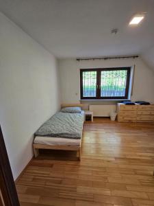 a bedroom with a bed in the corner of a room at Ferienzimmer in Bad Mergentheim-Wachbach in Bad Mergentheim