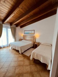 Postel nebo postele na pokoji v ubytování Hotel La Borgata