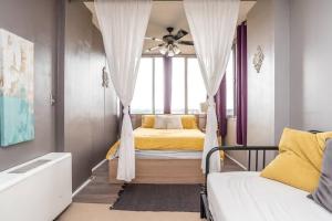 a bedroom with a bed with a ceiling fan at Downtown Atlanta Excellent View! Onsite Parking 1904 in Atlanta +20 photos