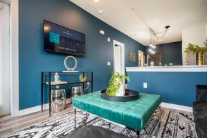 a living room with a blue wall and a table at Downtown New Built Roof top balcony City View 525Pkwy408 in Atlanta