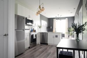 a kitchen with white appliances and a table in it at ATL Downtown New-Built Roof-top balcony City View 525#412 in Atlanta