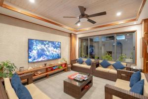 a living room with a couch and a ceiling fan at Ayala Oceanview Maldives in Gulhi