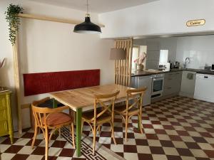a kitchen with a wooden table and chairs at L'Echoppe en ville in Amboise +17 photos