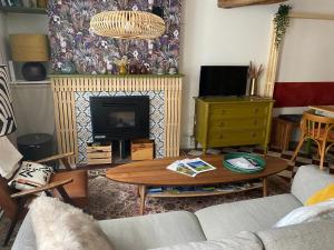 a living room with a couch and a fireplace at L'Echoppe en ville in Amboise
