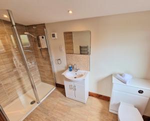 a bathroom with a shower and a sink at Torridon 1 with Private Hot Tub - Fife - Loch Leven - Lomond Hills- Pet Friendly in Kelty