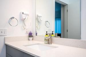a bathroom with a sink and a mirror at Luxe 1BR w Balcony in Downtown 542Blvd206 in Atlanta