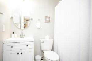 a white bathroom with a toilet and a mirror at NEW ENTIRE PLACE COZY QUIET 2b2b TOWNHOUSE SP1275 in Norcross