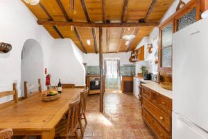 a kitchen with wooden ceilings and a large wooden table at Sagres, Aloha Beach House, 500 meters from Tonel beach in Sagres +31 photos
