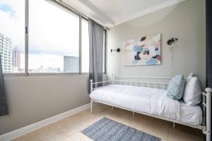 a white bedroom with a bed and a window at Atlanta Downtown! City Life! ONSITE PARKING LM1701 in Atlanta
