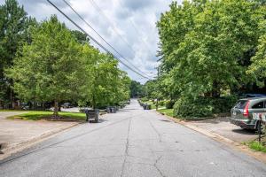 an empty street with trees and parked cars at NEW ENTIRE PLACE COZY QUIET 2b2bTOWNHOUSE SP1273 in Norcross