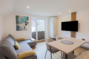 a living room with a couch and a table at Apartments BB in Bohinj
