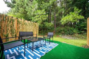 a patio with two chairs and a table on green grass at NEW 2b2b ENTIRE TOWNHOUSE PLACE COZY and QUIET in Norcross