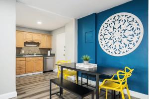 a kitchen with a dining table and yellow chairs at Atlanta Downtown City View Condo Free Parking LM1606 in Atlanta