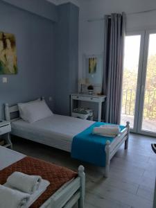 una camera con due letti e una finestra di Dimitris Apartments Messongi a Mesongi