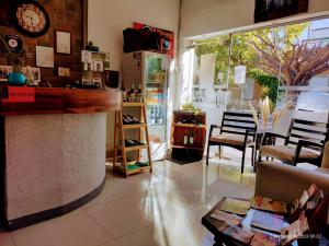 a store with a counter and chairs and a clock at Hotel Francia in San Rafael