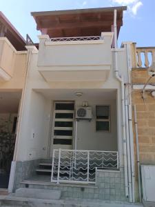 a white house with stairs and a balcony at Casa Beatrice in Specchiolla