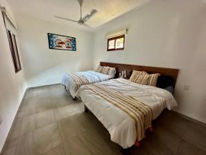 a bedroom with two beds in a room at El Tular 2 Bdr Appartment 2 min walk from La Ropa beach in Zihuatanejo