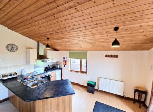 a kitchen with wooden ceilings and a counter top at Lomond 3 with Private Hot Tub - Fife - Loch Leven - Lomond Hills -Pet Friendly in Kelty +11 photos